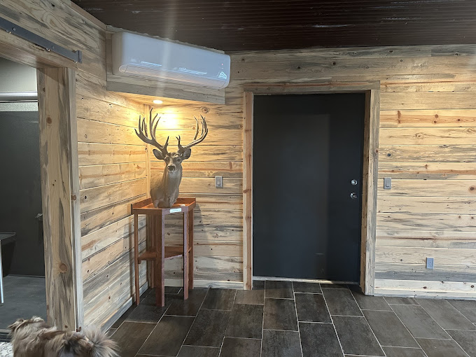 Barndominium entry with wood plank walls and dark tile floor near Seminole, OK