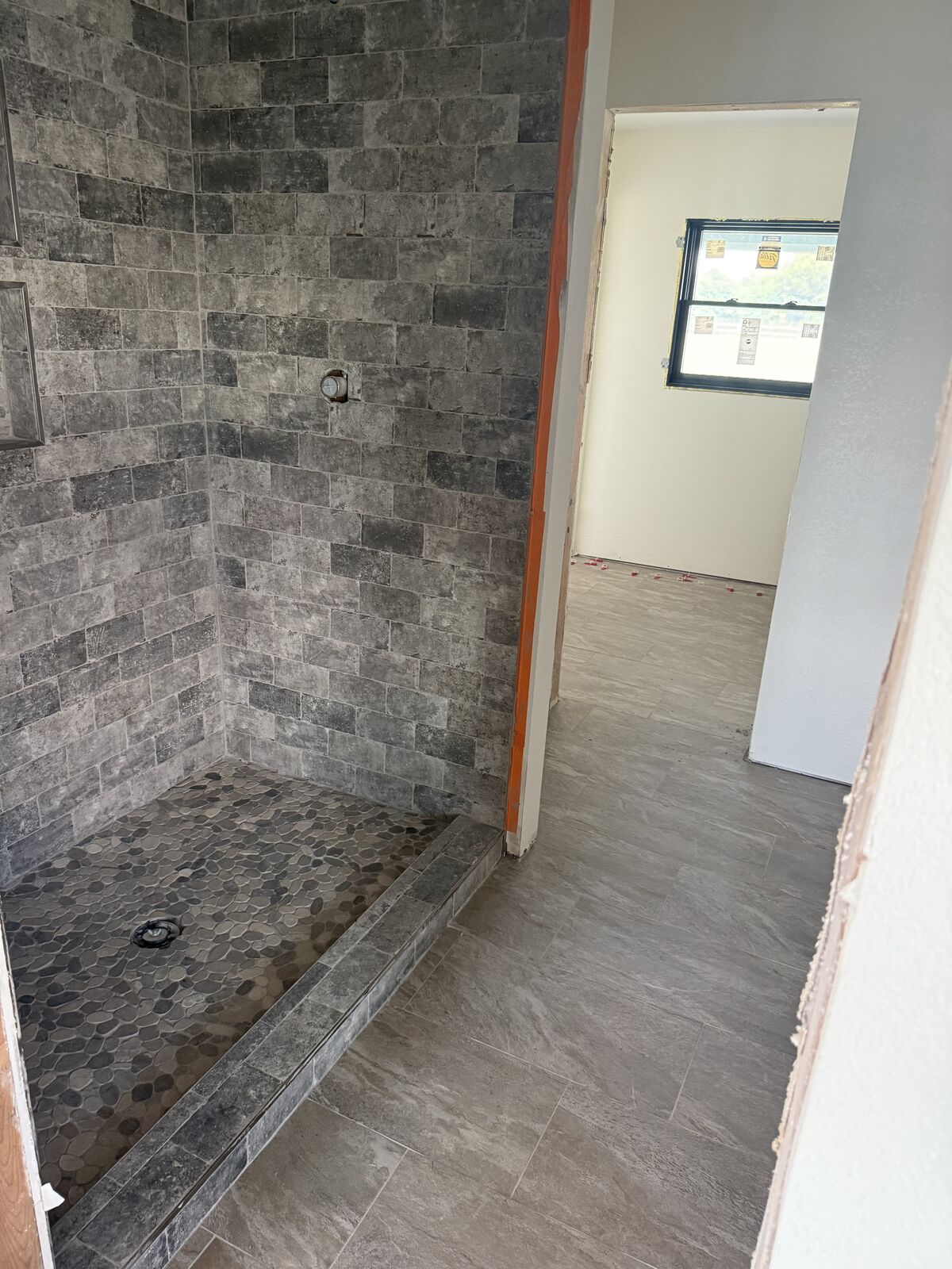 Gray stone tile shower installed during a bathroom remodel near Seminole, OK