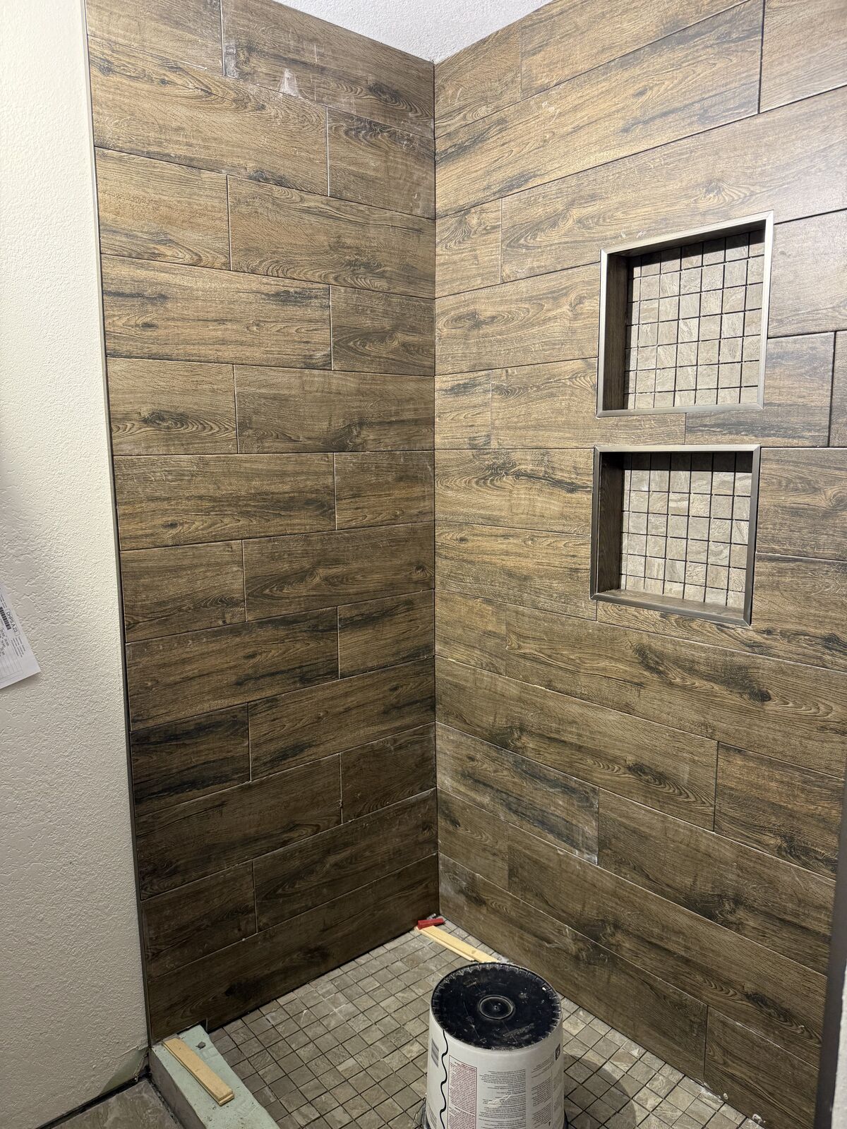 Custom tile walk-in shower with dual storage niches built during an Oklahoma bathroom remodel