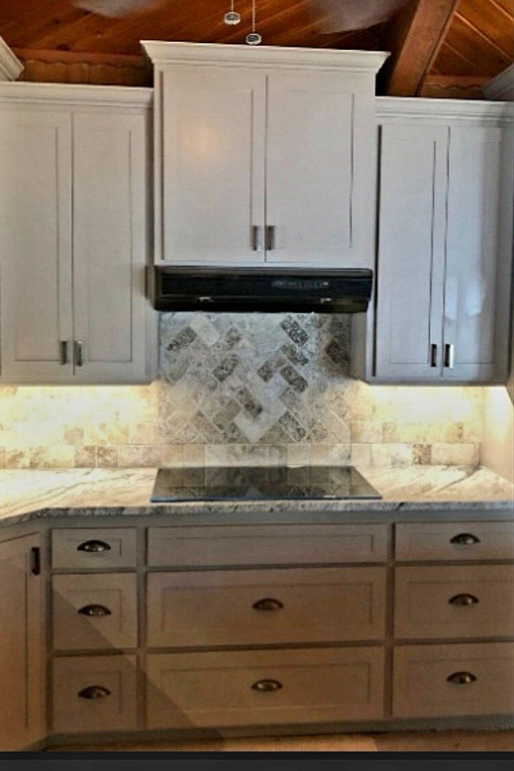 Custom kitchen cabinets with stone tile backsplash installed by Smith Construction in Oklahoma