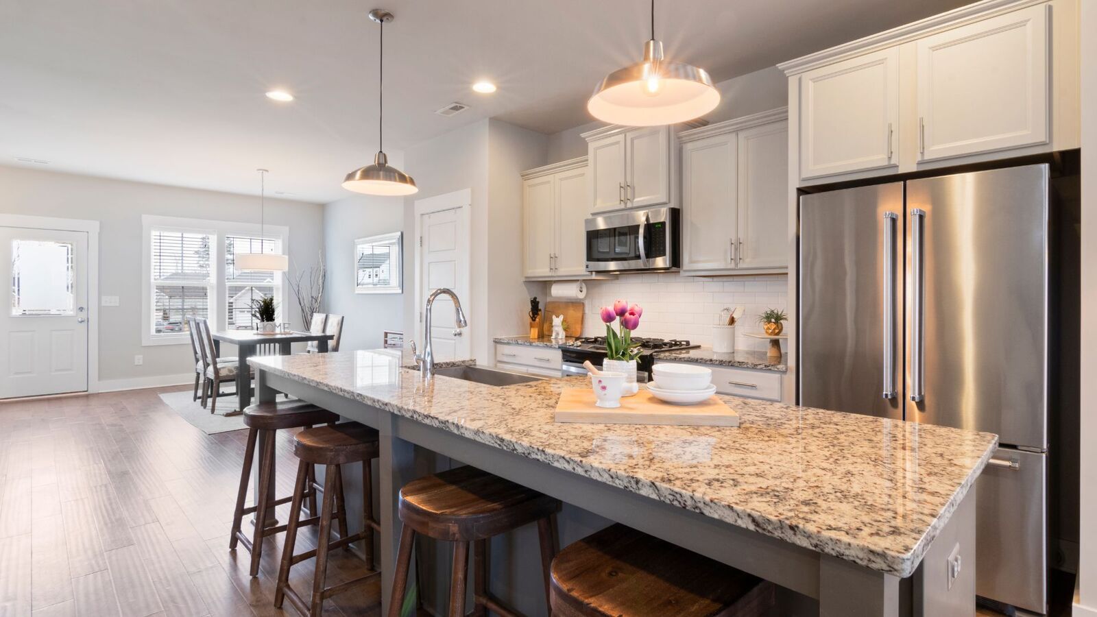Open-concept kitchen remodel with granite island and stainless appliances