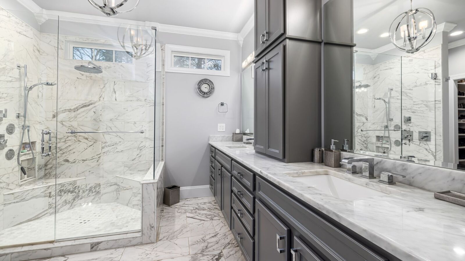 Master bath remodel with dark cabinets, marble counters, and glass shower