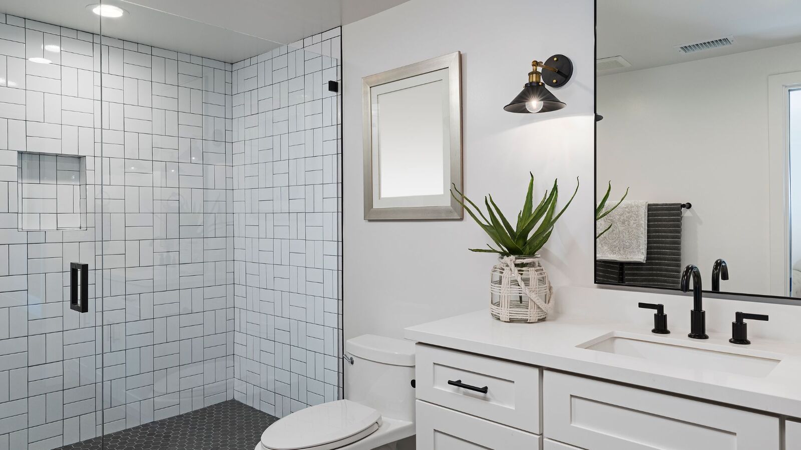 Bathroom remodel with white subway tile walk-in shower and hex tile floor