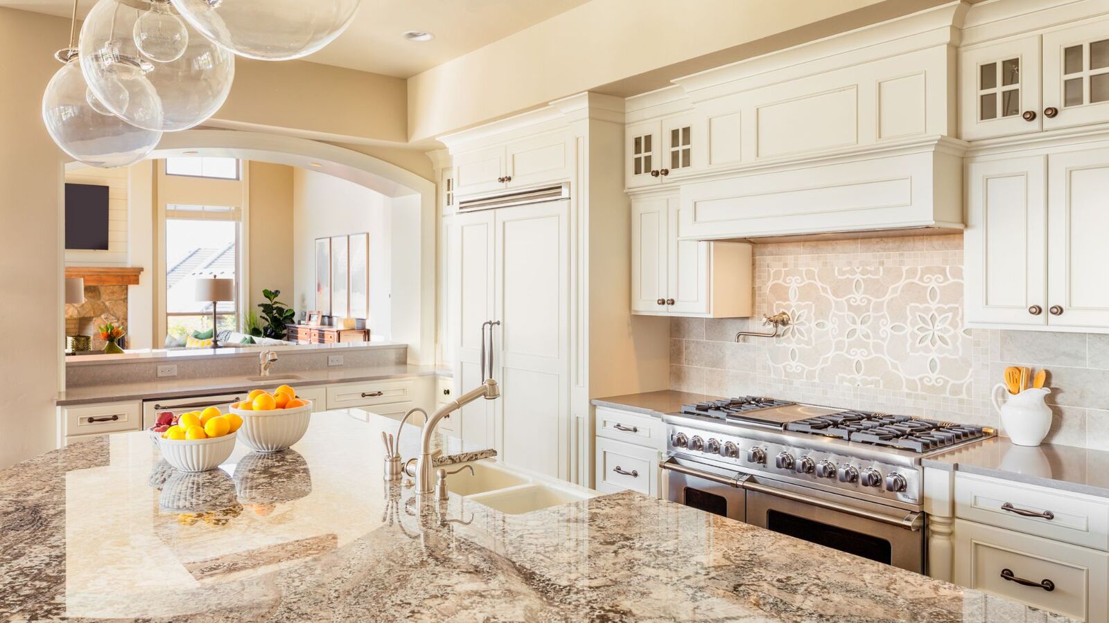 Traditional kitchen remodel with cream cabinets and stone backsplash