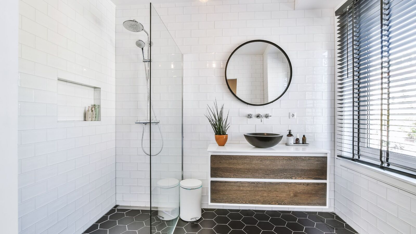 White bathroom remodel with glass walk-in shower and floating vanity
