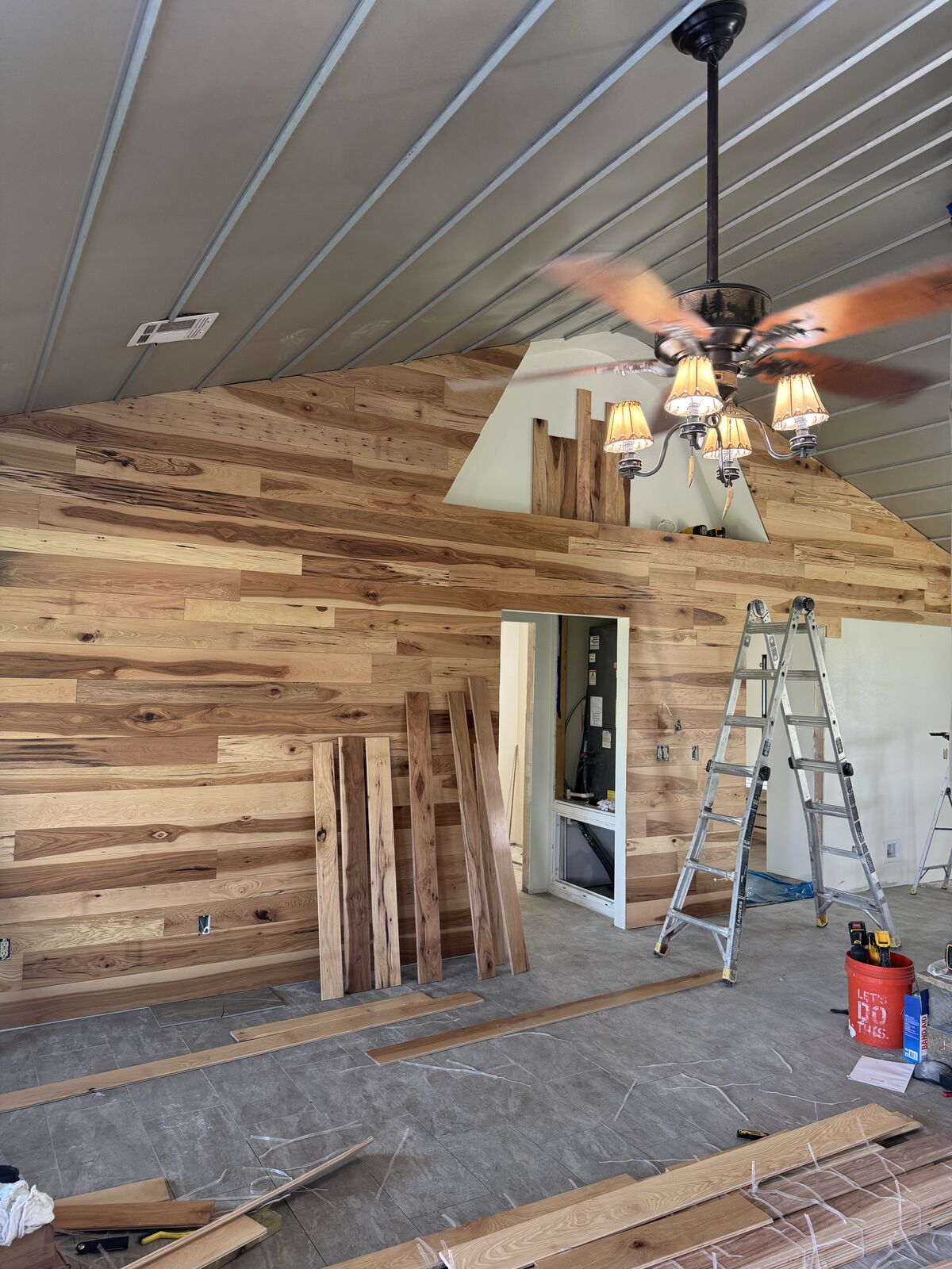 Smith Construction crew installing a hickory accent wall inside an Oklahoma barndominium